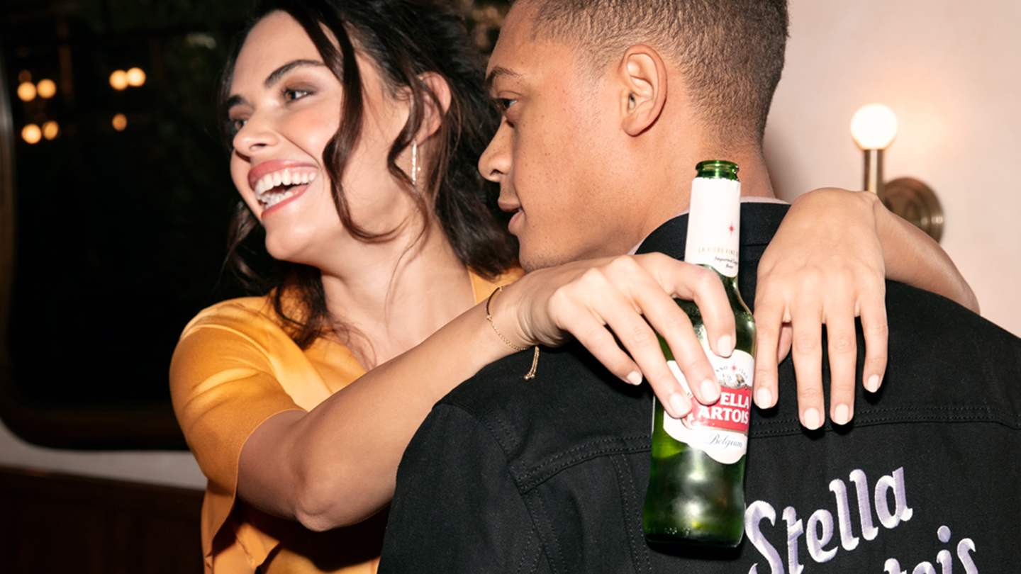 Man and woman dancing while enjoying Stella Artois Lager